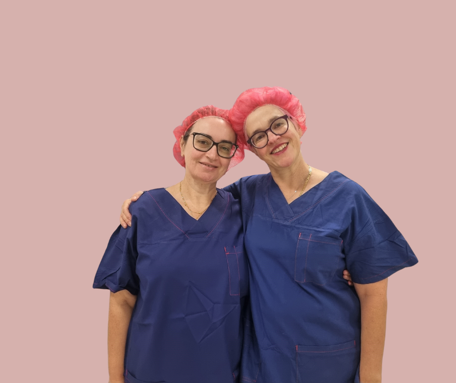 Dr Lucia Saliba and Dr Felicity Re in scrubs on a pink background