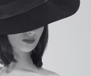 Monochrome picture of woman in black wide brimmed hat